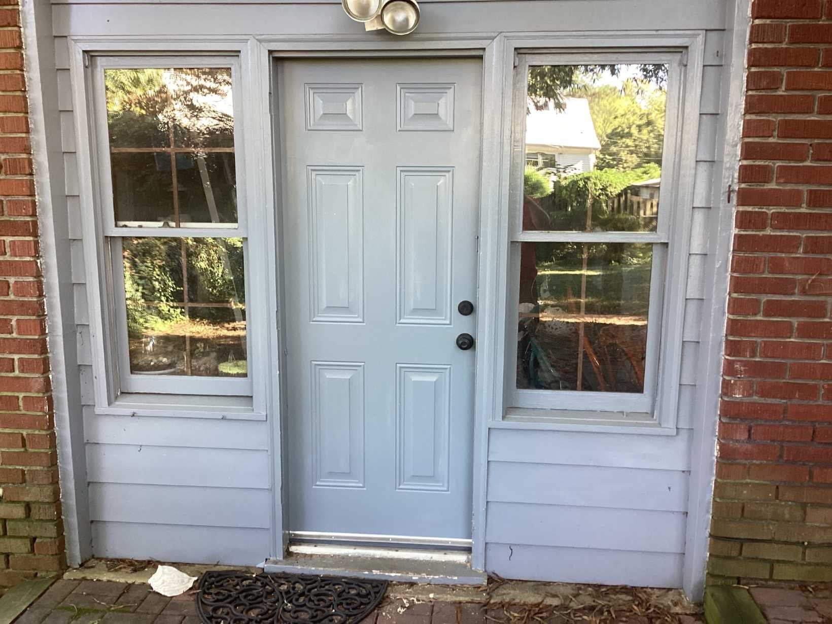 https://acehandyman-dss.ingeniuxondemand.com/Images/Offices/North Carolina/Greater Triangle/Photos/23781914-Ace-Handyman-Services-raleigh-nc-27605-door-replacement-exterior-after.jpg Newly installed light blue six-panel exterior door with sidelight windows at a Raleigh, NC home