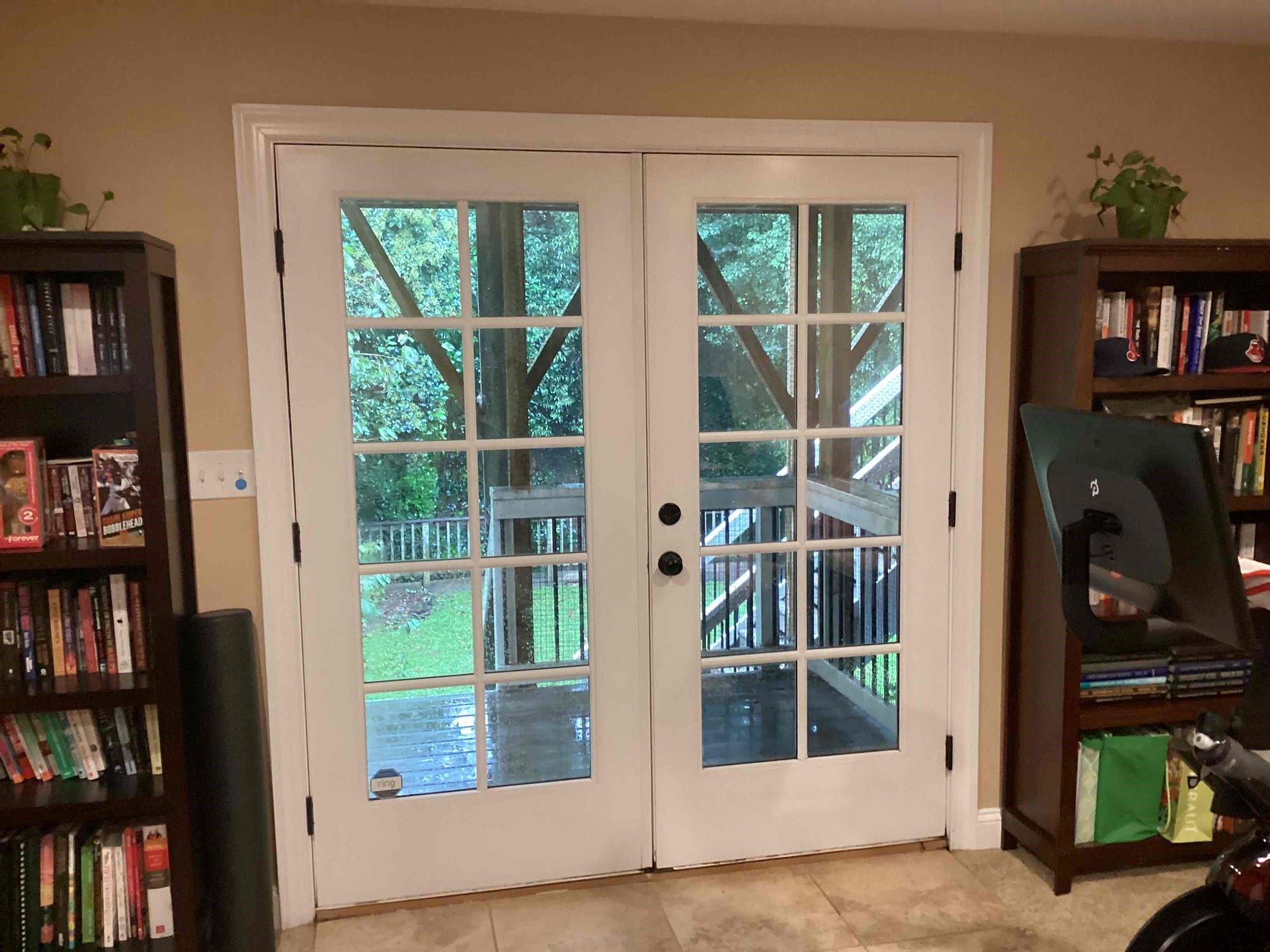 Glass double doors leading to an outdoor area; interior view.