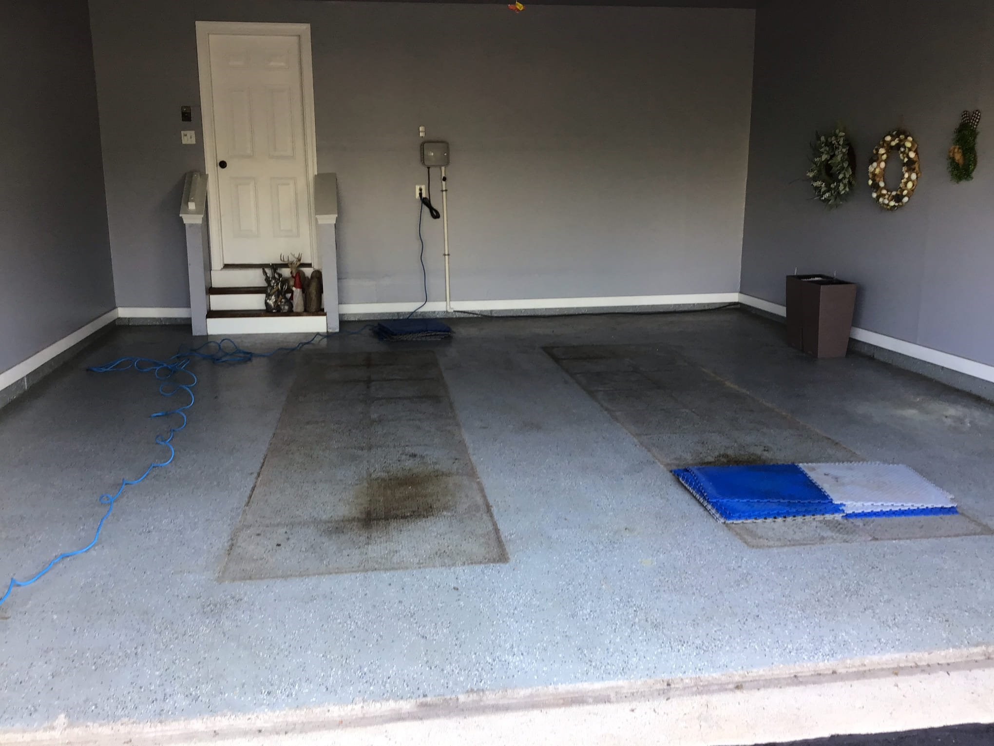 Empty garage with marked floor and wall decorations.