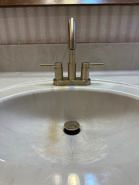 Bathroom sink with new faucet installation.