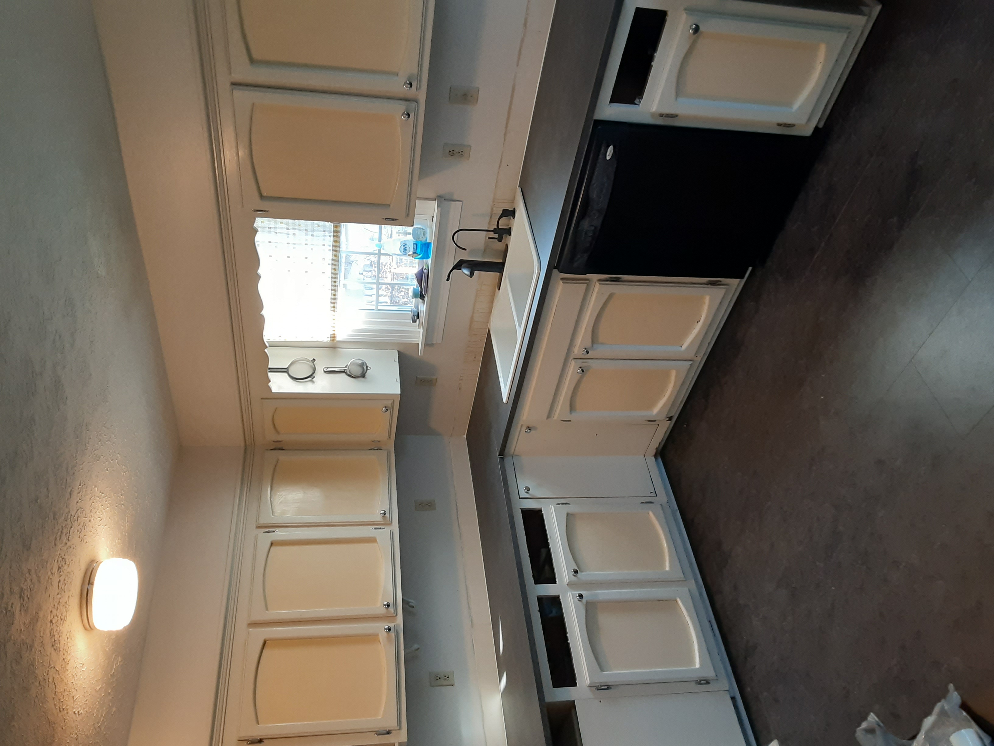 Kitchen cabinets with unpainted and unfinished doors.